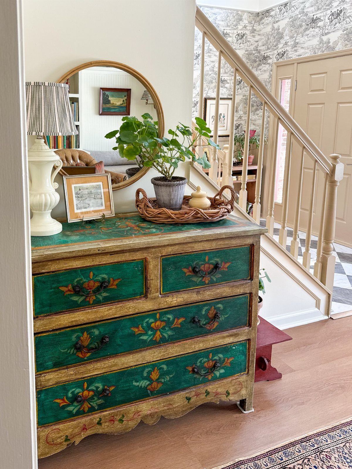 Ornate green and gold dresser with storage drawers in a home interior setting