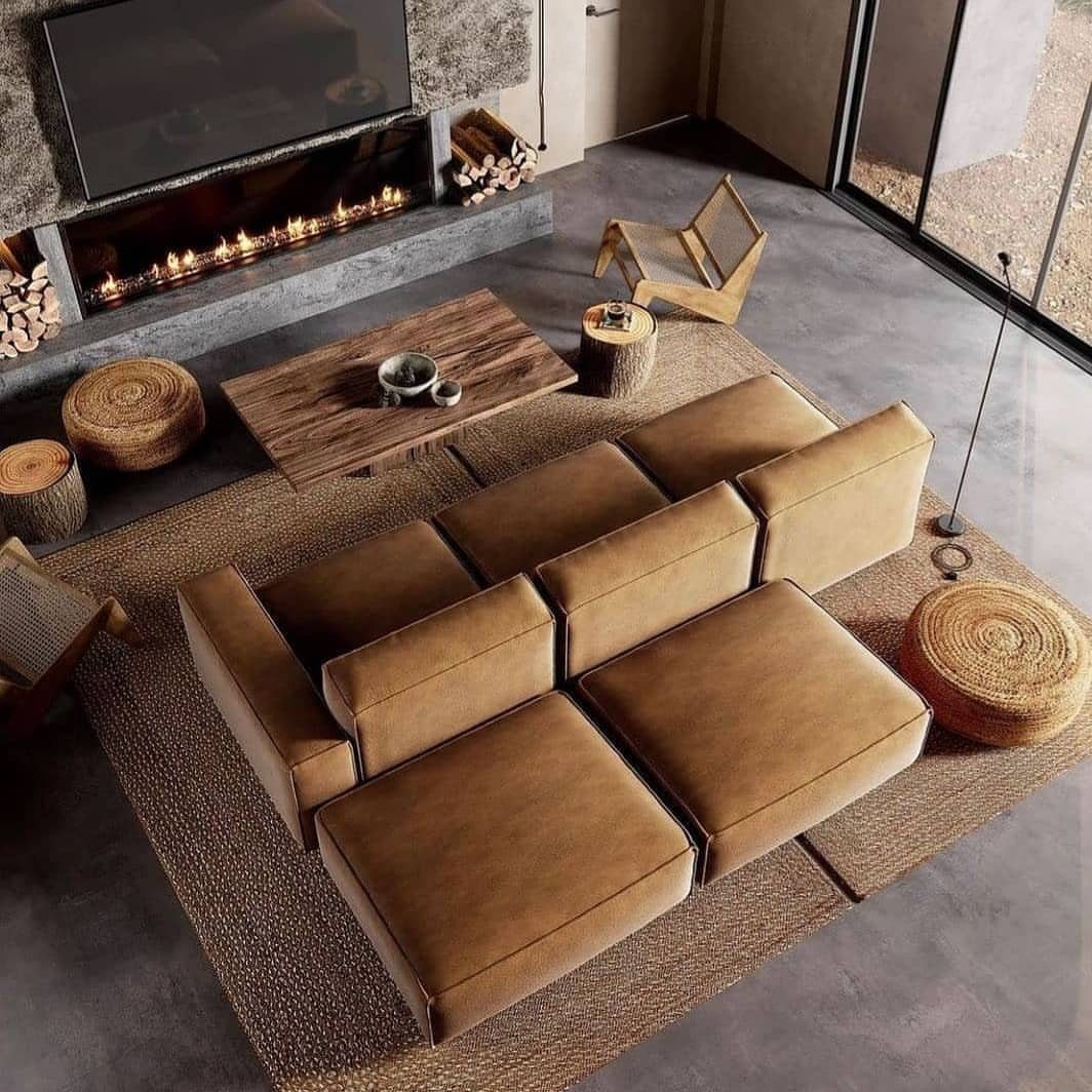 Brown leather L-shaped modular sofa in a modern living room with a fireplace.